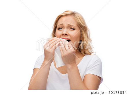 unhappy woman with paper napkin sneezing 20173054
