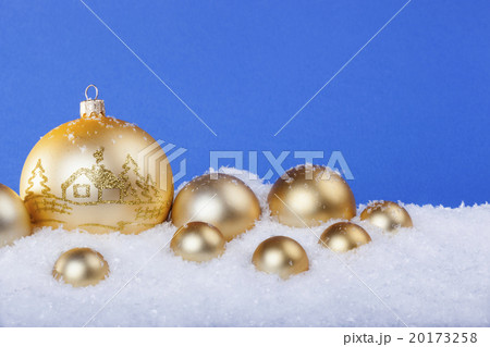 gold Christmas balls in the snow 20173258