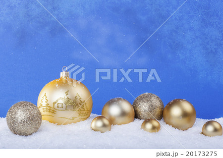 gold Christmas balls in the snow 20173275