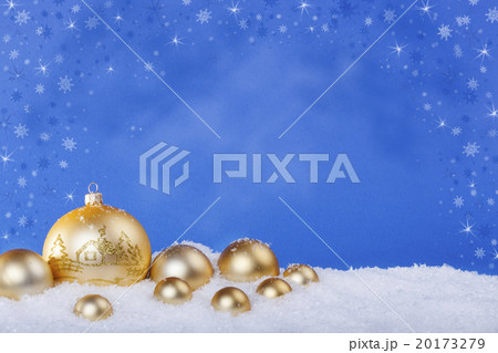 gold Christmas balls in the snow 20173279