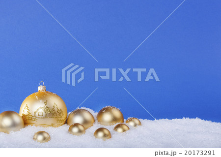 gold Christmas balls in the snow 20173291