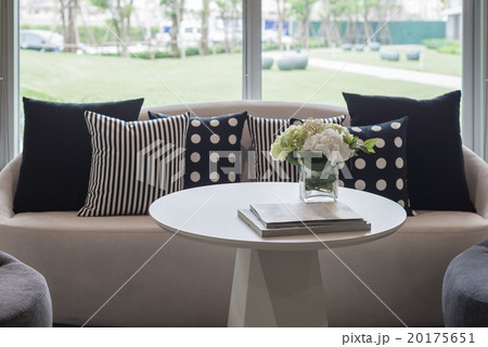 vase of flower on round table with pillows 20175651