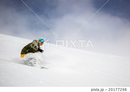 Man snowboarding on snow in the mountains 20177298