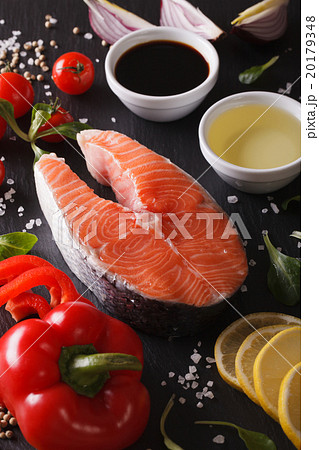 Raw salmon and ingredients on a slate board macro 20179348