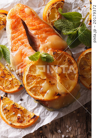baked salmon with oranges close-up on the table baked salmon with oranges close-up on the table 20179372