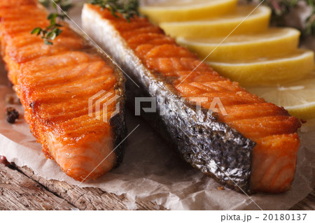 Delicious grilled salmon with lemon on the paper Delicious grilled salmon with lemon on the paper 20180137