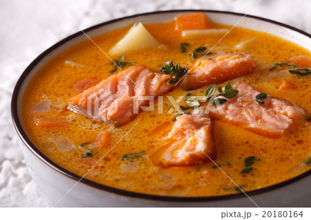 Rich salmon soup with thyme macro in a white bowl Rich salmon soup with thyme macro in a white bowl 20180164