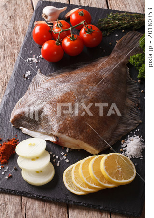 raw flounder with ingredients on a slate board 20180353
