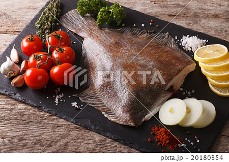 Fresh raw plaice with ingredients on a slate board 20180354