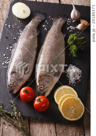 Two raw rainbow trout with ingredients 20180371