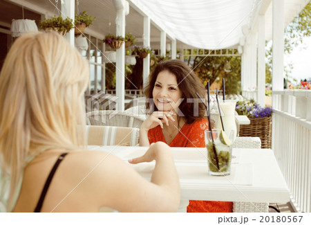 portrait of two pretty friends in cafe interior 20180567