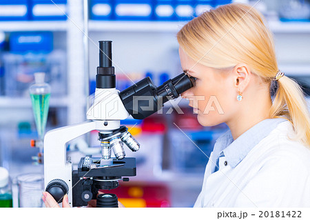 Scientist using a microscope in a laboratory Scientist using a microscope in a laboratory 20181422