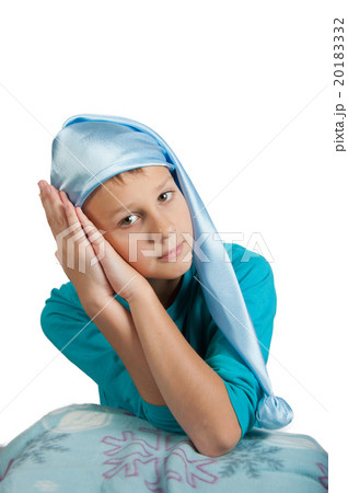 Boy in pajamas and sleeping hat  isolated on white 20183332