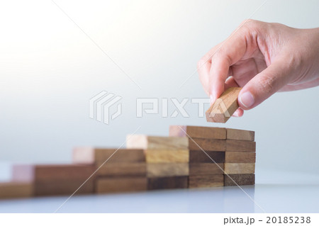 Hand aranging wood block stacking as step stair. Hand aranging wood block stacking as step stair. 20185238