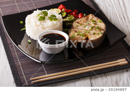Baked fish, rice, vegetables and soy sauce 20194897