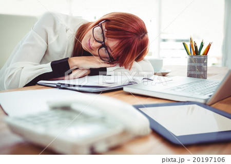 Hipster businesswoman falling in sleep at her desk Hipster businesswoman falling in sleep at her desk 20197106