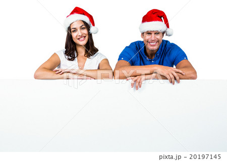 Man and woman wearing Santa hat  20197145