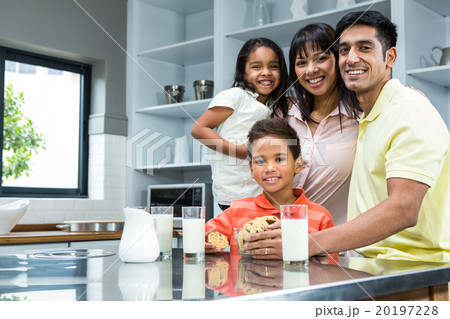 Happy family in the kitchen ready to eat biscuits Happy family in the kitchen ready to eat biscuits 20197228