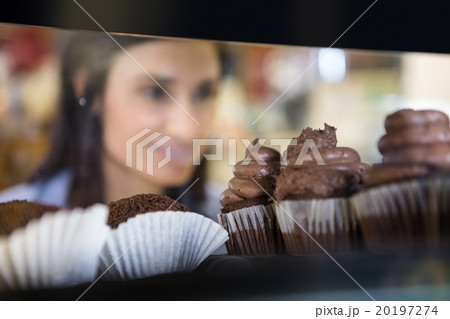 Pretty smiling woman choosing her dessert Pretty smiling woman choosing her dessert 20197274