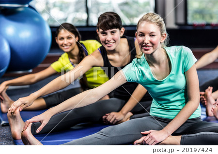 Fit smiling group doing stretching 20197424