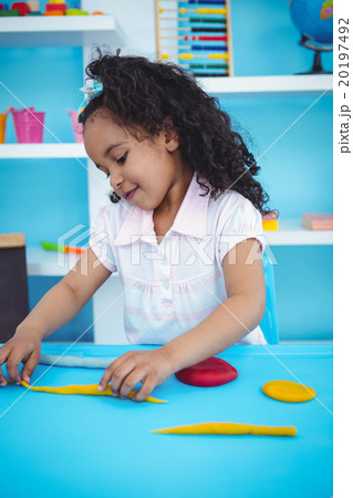 Cute girl playing with modeling clay Cute girl playing with modeling clay 20197492