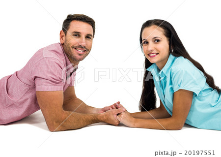 Happy couple laying on the floor face to face holding hands 20197551