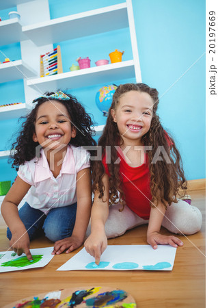 Cute girls painting with their fingers Cute girls painting with their fingers 20197669
