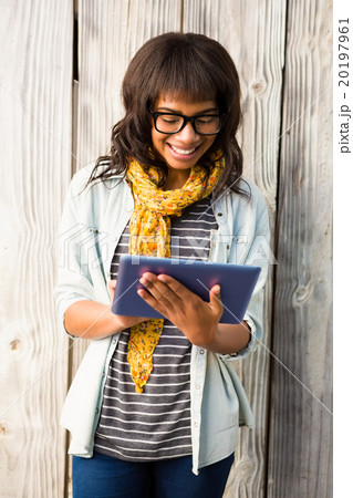 Smiling casual woman using her tablet Smiling casual woman using her tablet 20197961