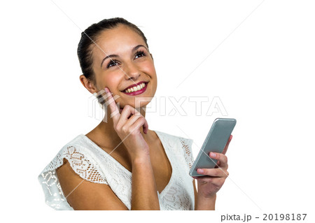 Smiling thoughtful woman holding smartphone Smiling thoughtful woman holding smartphone 20198187