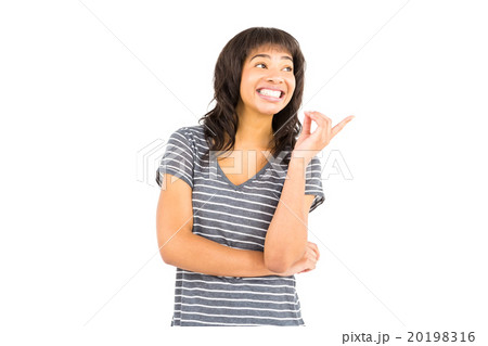 Smiling casual woman pointing somethings in the air 20198316