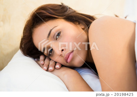 Sleepy woman in her bed 20198425