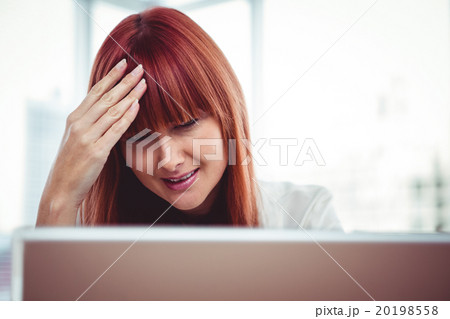 Hipster businesswoman having a headache 20198558