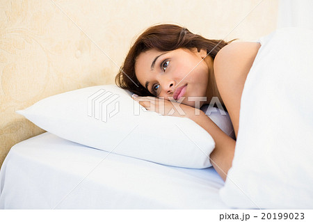 Sleepy woman in her bed 20199023