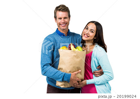 Couple holding bag of fruits Couple holding bag of fruits 20199024