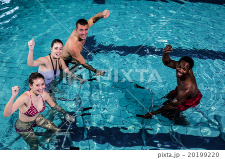 Fitness class doing aqua aerobics on exercise bikes 20199220