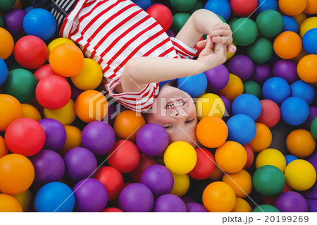 Cute smiling boy in sponge ball pool Cute smiling boy in sponge ball pool 20199269