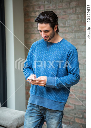 Handsome man using smartphone 20199633