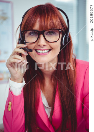 Smiling hipster businesswoman with headset 20199677