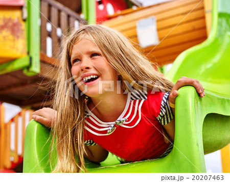 Child girl upside down on playground . Child girl upside down on playground . 20207463