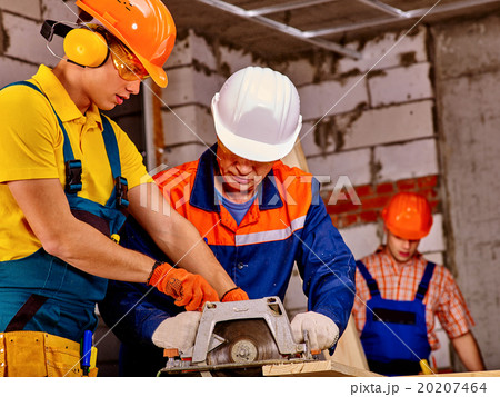 Group people  builder with circular saw . 20207464