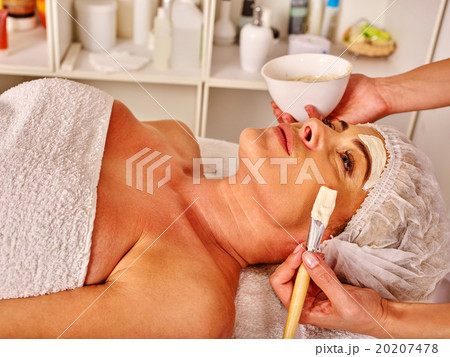 Woman middle-aged take facial and neck anti-aging 20207478
