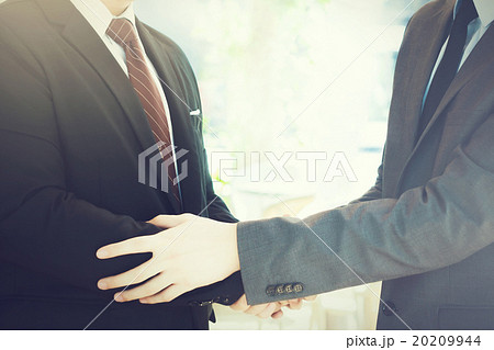 Two businessmen giving warm welcome, teamwork Two businessmen giving warm welcome, teamwork 20209944