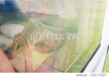 Beautiful woman in a camper van 20217635
