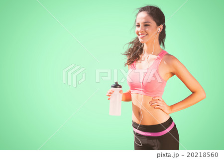 Composite image of beautiful smiling healthy woman holding water bottle Composite image of beautiful smiling healthy woman holding water bottle 20218560