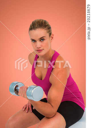 Composite image of muscular woman exercising with dumbbells  20218679