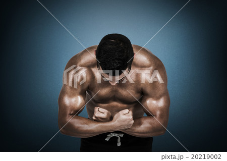 Composite image of muscular man flexing for camera 20219002