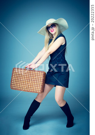The traveler woman standing with retro suitcase The traveler woman standing with retro suitcase 20222355