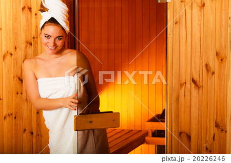 woman relaxing in wooden sauna room woman relaxing in wooden sauna room 20226246