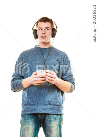 Young man with headphones listening music Young man with headphones listening music 20226523