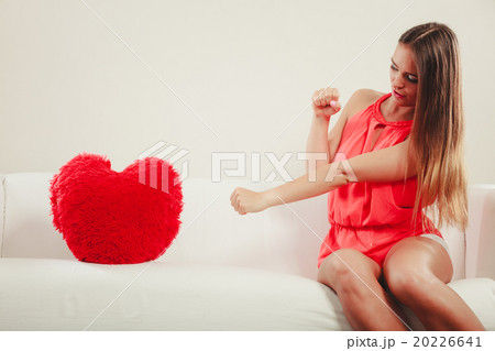Sad woman with heart shape pillow. Valentines day. 20226641